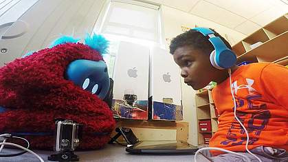 Image of a preschooler interacting with a social robot 
