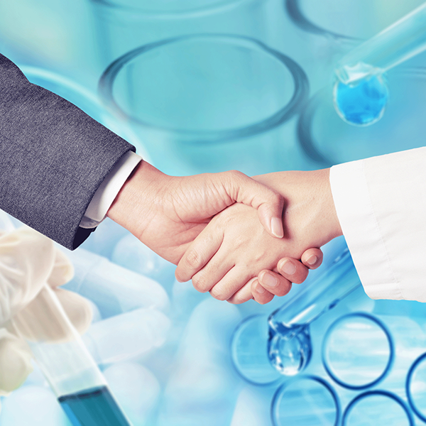 Close-up of a business man shaking hands with a female researcher.