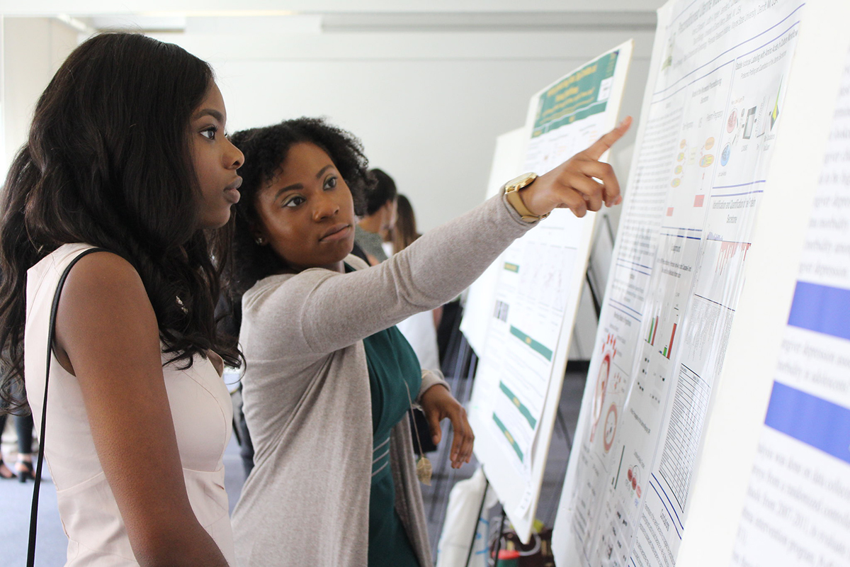 Participants/trainees engaging with material presented on a poster