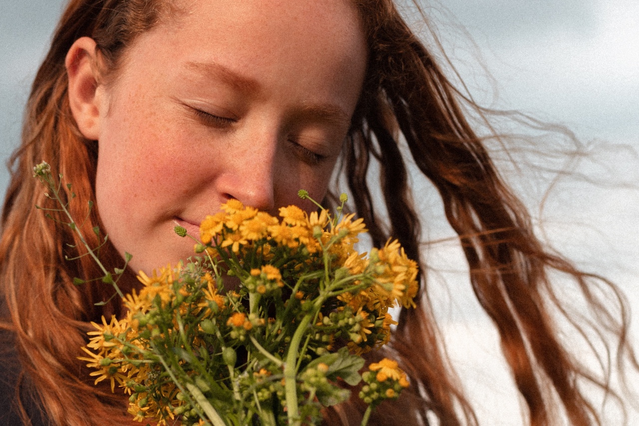 Girl smelling flowers.