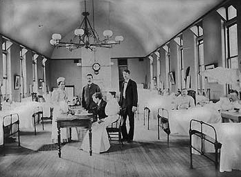 Dr. Joseph Goldberger seated at a table in a hospital Dr. Joseph Goldberger seated at a table in a hospital.