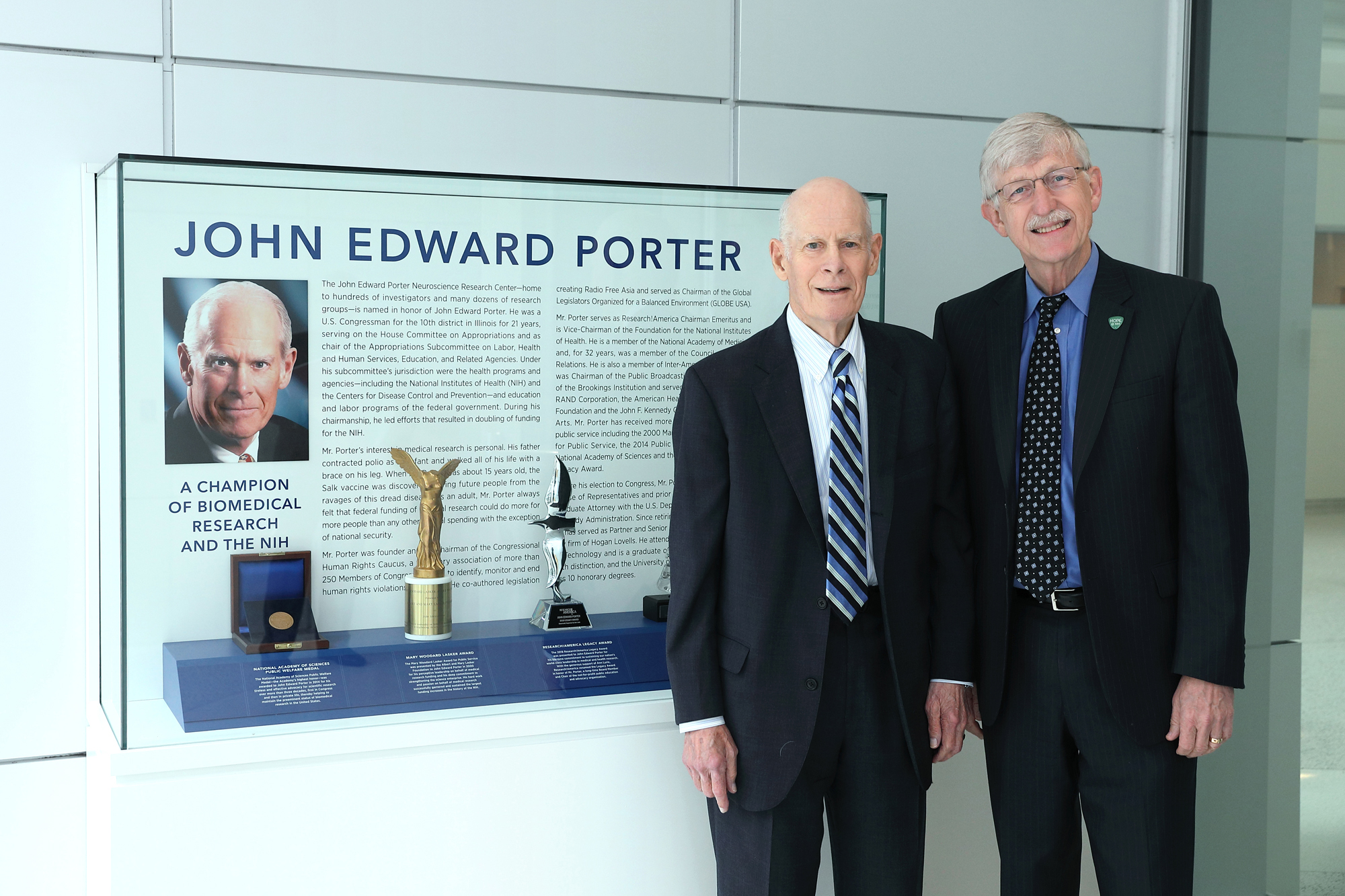 Congressman John Edward Porter (left) and NIH Director Dr. Francis Collins pose next to an exhibit honoring the Congressman’s strong leadership on behalf of NIH research.