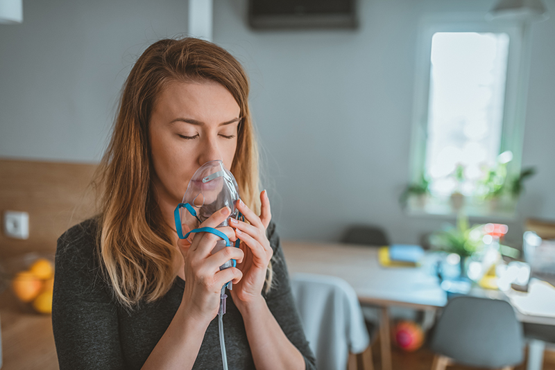 Woman using inhaler