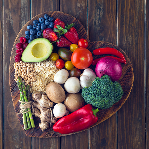 An assortment of healthy foods on a heart shaped plate