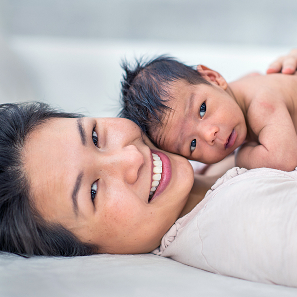 A baby lying on its mother's chest