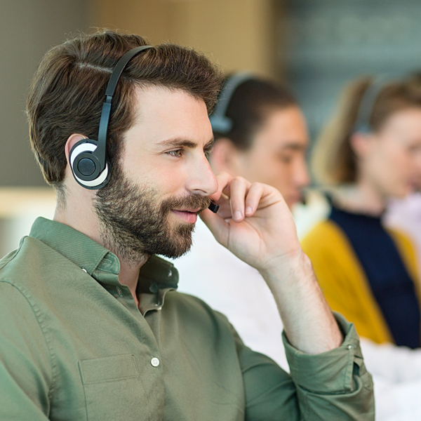 Information specialists at a contact center wearing phone headsets