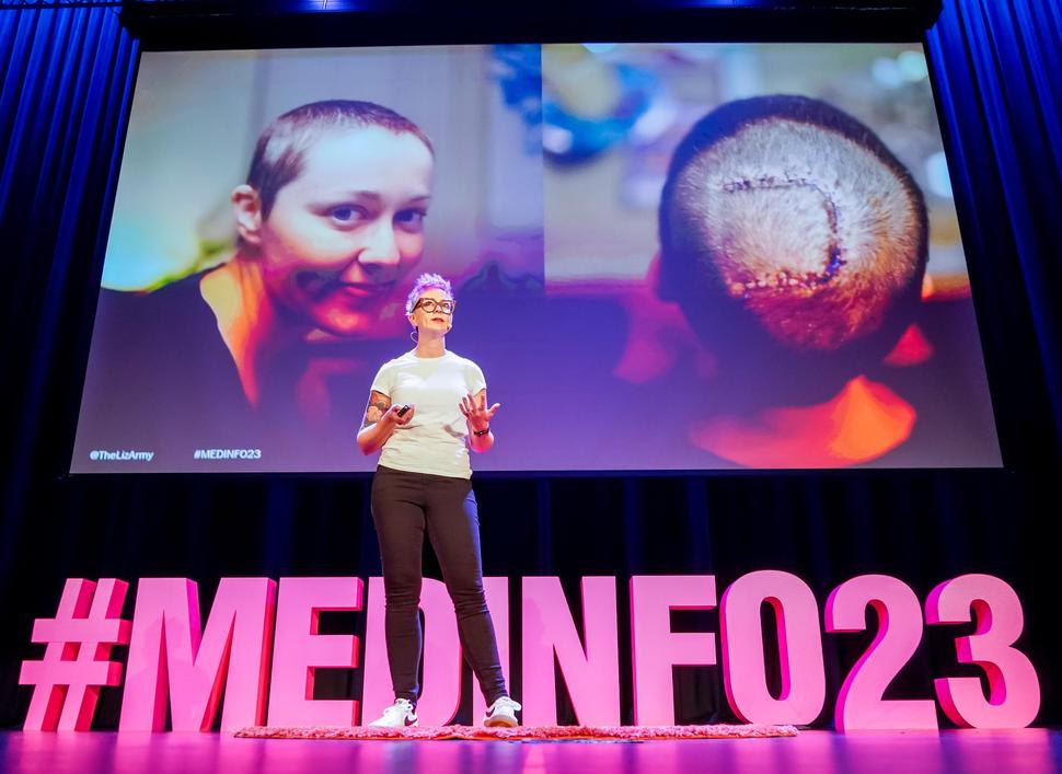 Liz Salmi standing on stage during the MedInfo23 conference