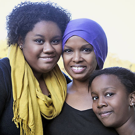 Mother standing with daughters.