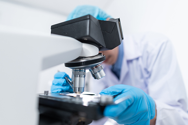 Scientist using a microscope