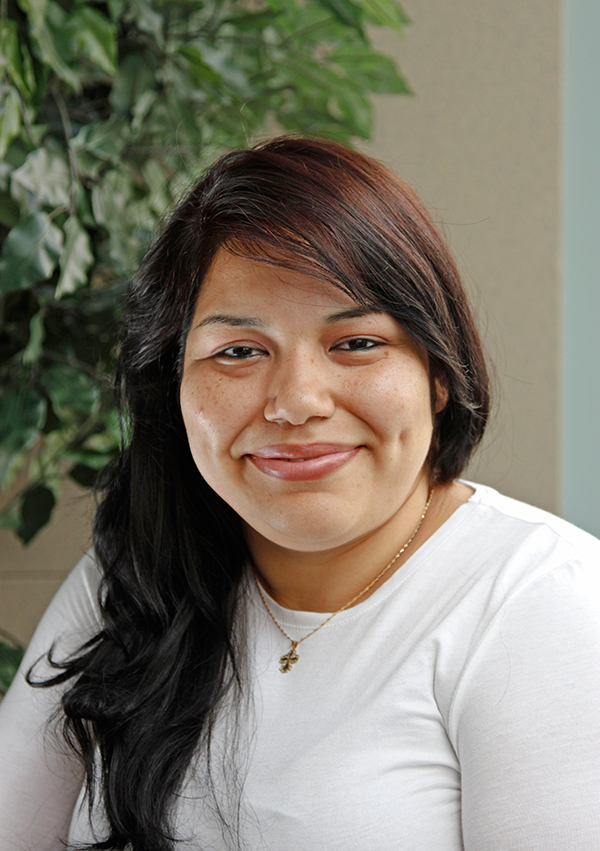 A young Hispanic woman smiling.