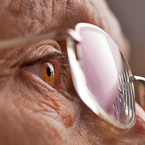 A closeup of a senior woman’s eye and glasses