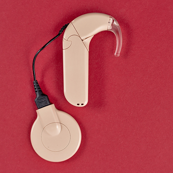 A cochlear implant on top of a red background