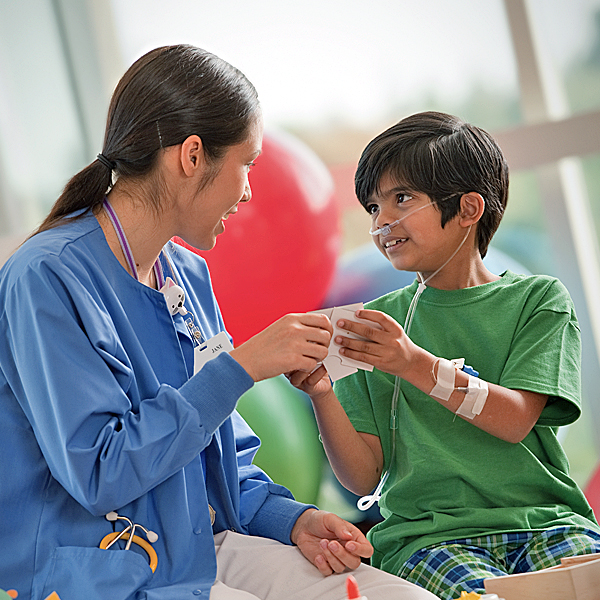 A doctor interacting with a young patient in the hospital