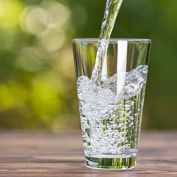 Water being poured into a glass cup