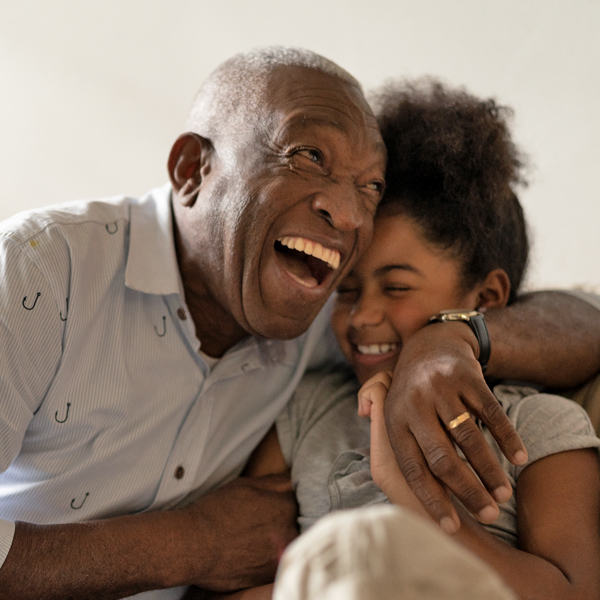 A grandfather and granddaughter laughing together