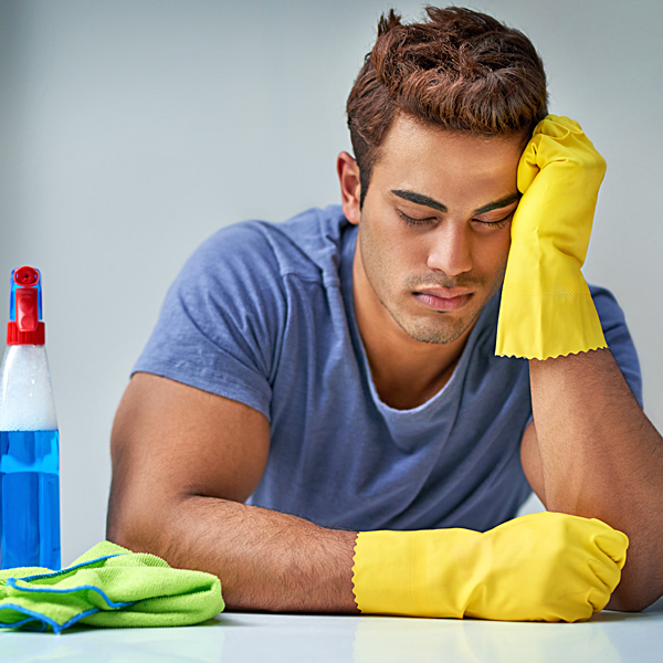 A man exhausted after cleaning
