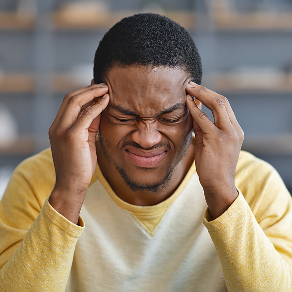 A man holding his head in pain