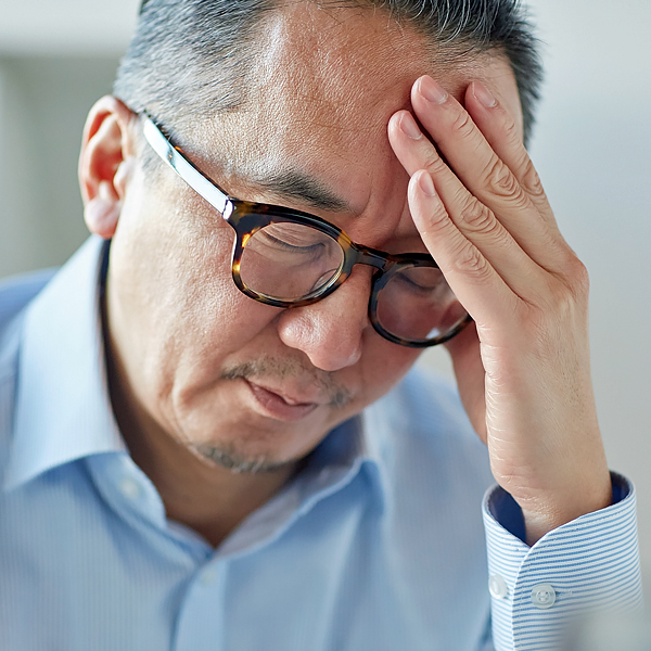 A man holding his head in pain