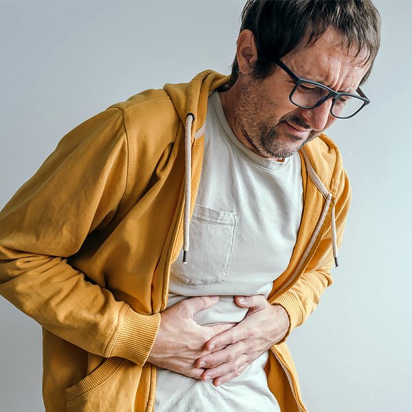 A man holding his stomach in pain