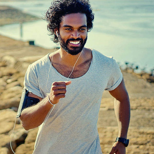 A man jogging by the shore