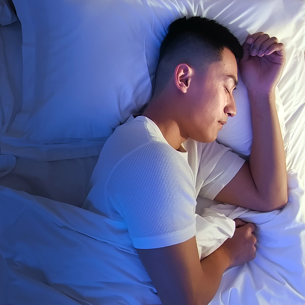 A man sleeping on his side in bed