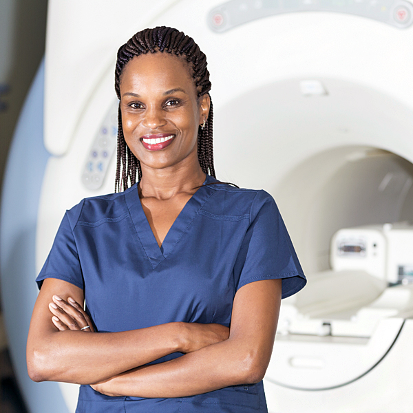 A radiologist standing in front of an MRI machine