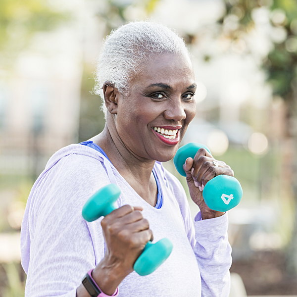 A senior woman exercising with hand weights
