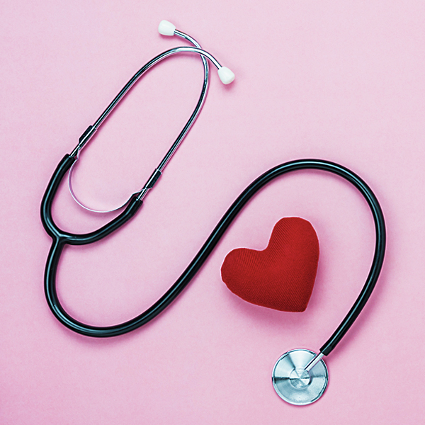 A stethoscope wrapped around a plush red heart
