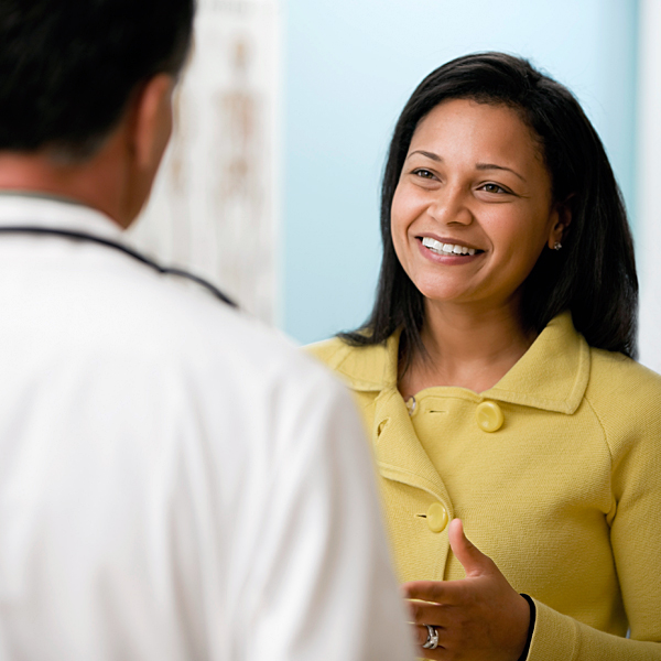 A woman talking with a doctor