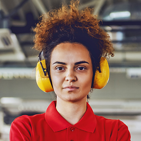 A woman at work wearing protective earmuffs