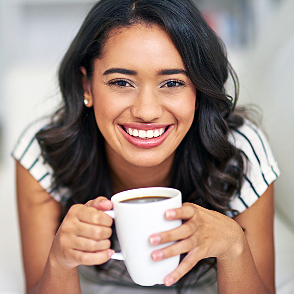 A young woman holding a cup of coffee