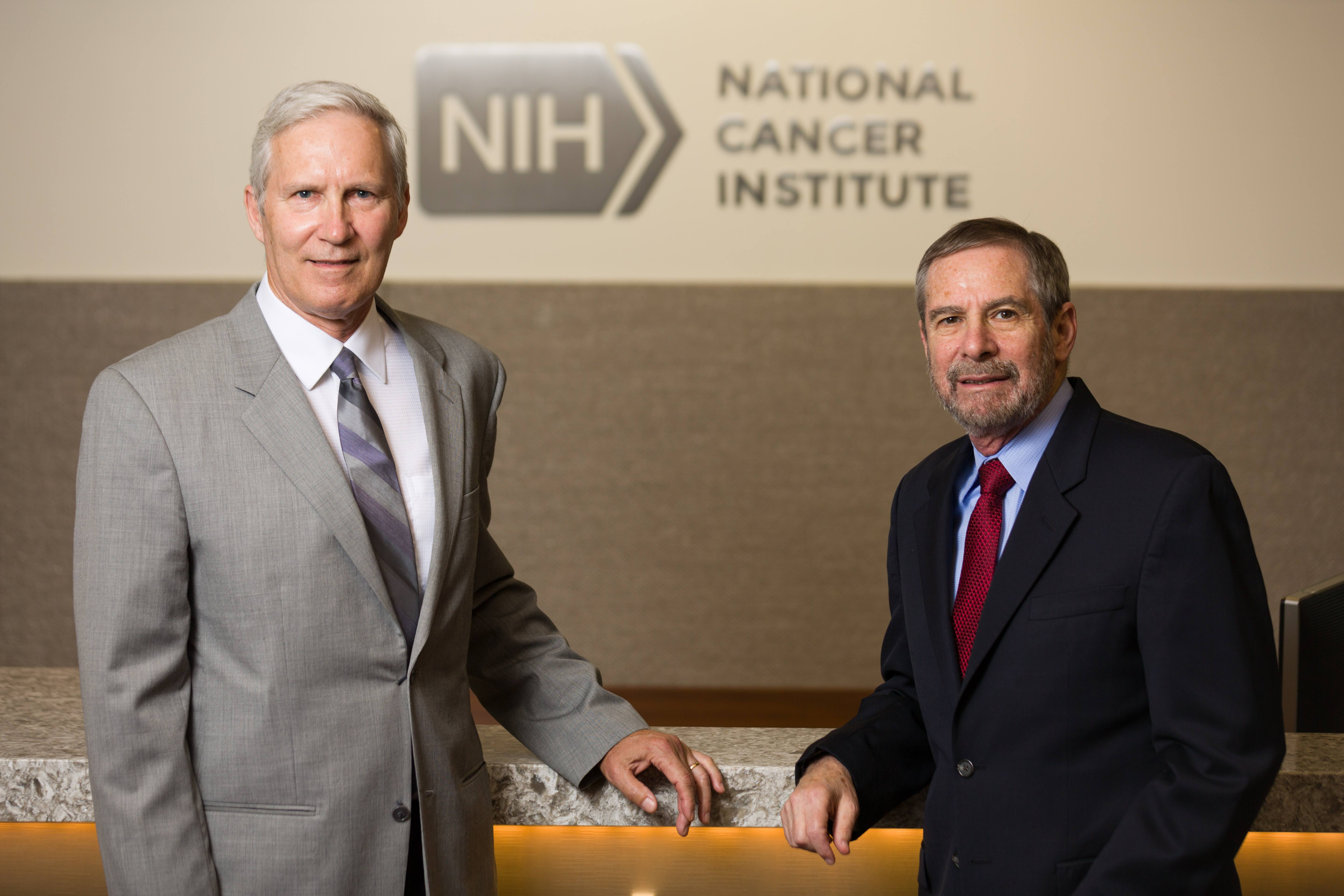 Schiller and Lowy in front of the NCI logo John T. Schiller and Douglas R. Lowy standing in front of the NCI logo