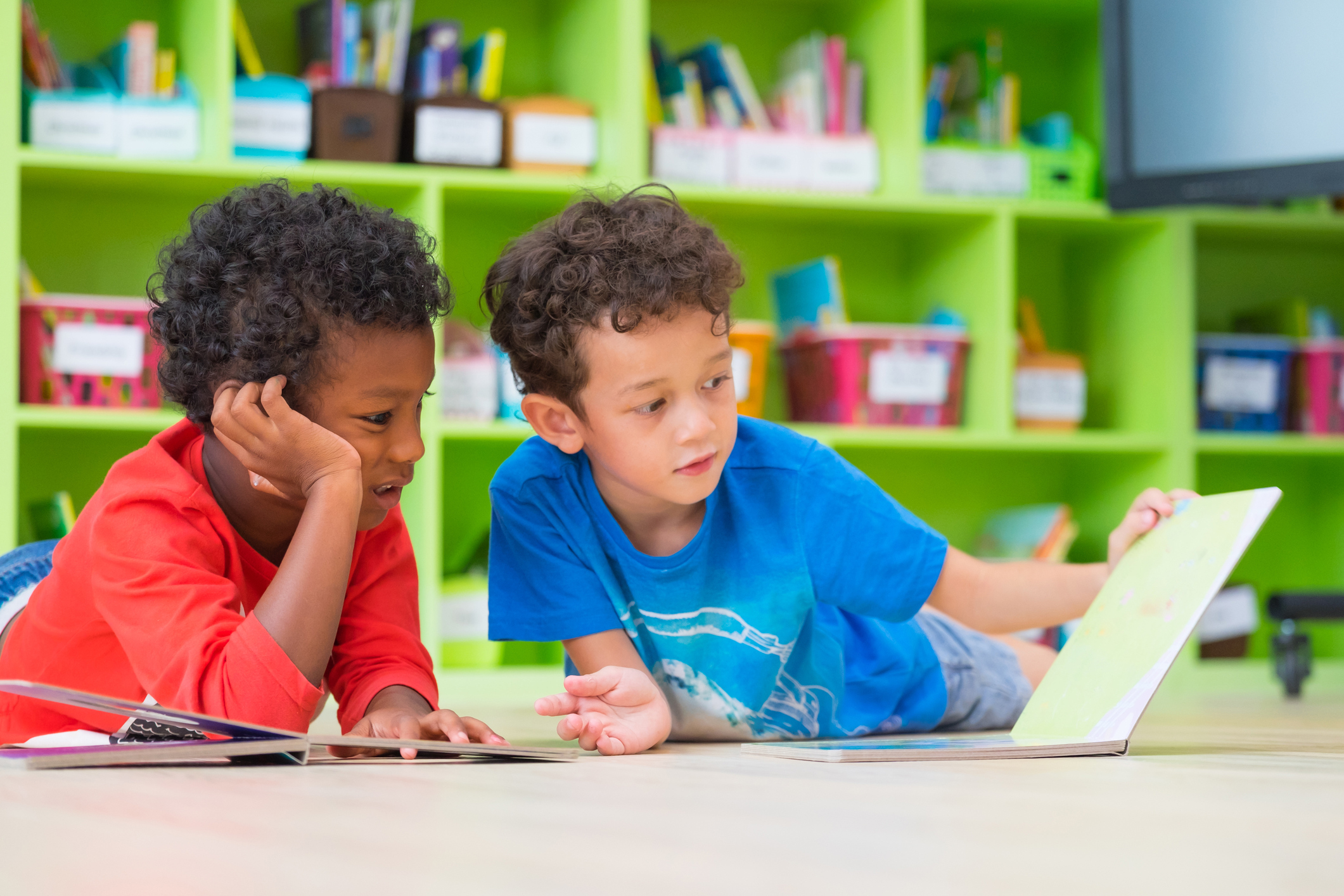 Preschoolers reading a book.