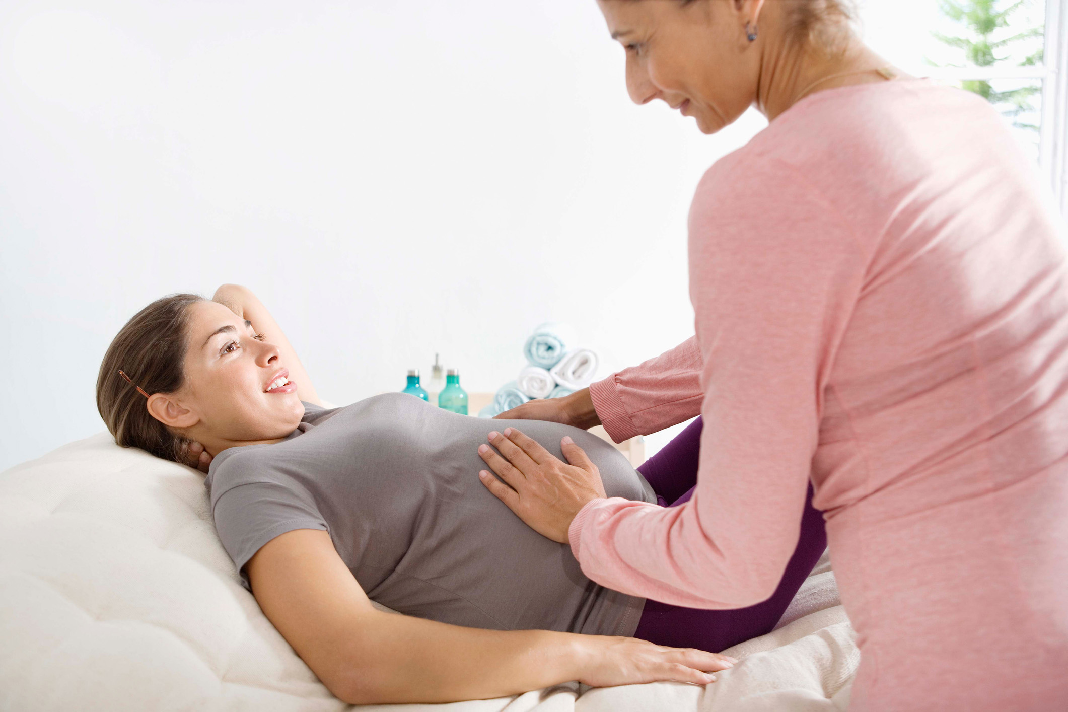 Pregnant woman talking with midwife. 