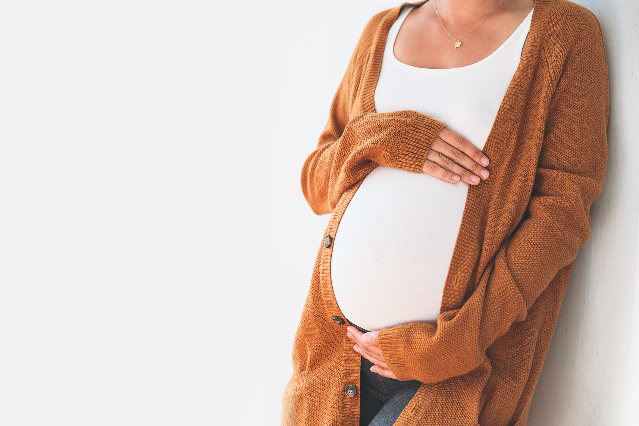 Image of a pregnant woman holder her stomach.