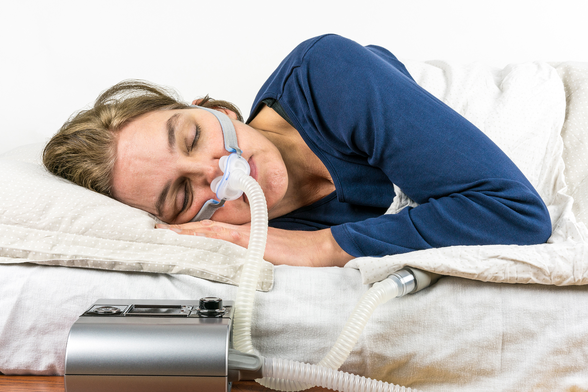 Image of a woman with sleep apnea machine
