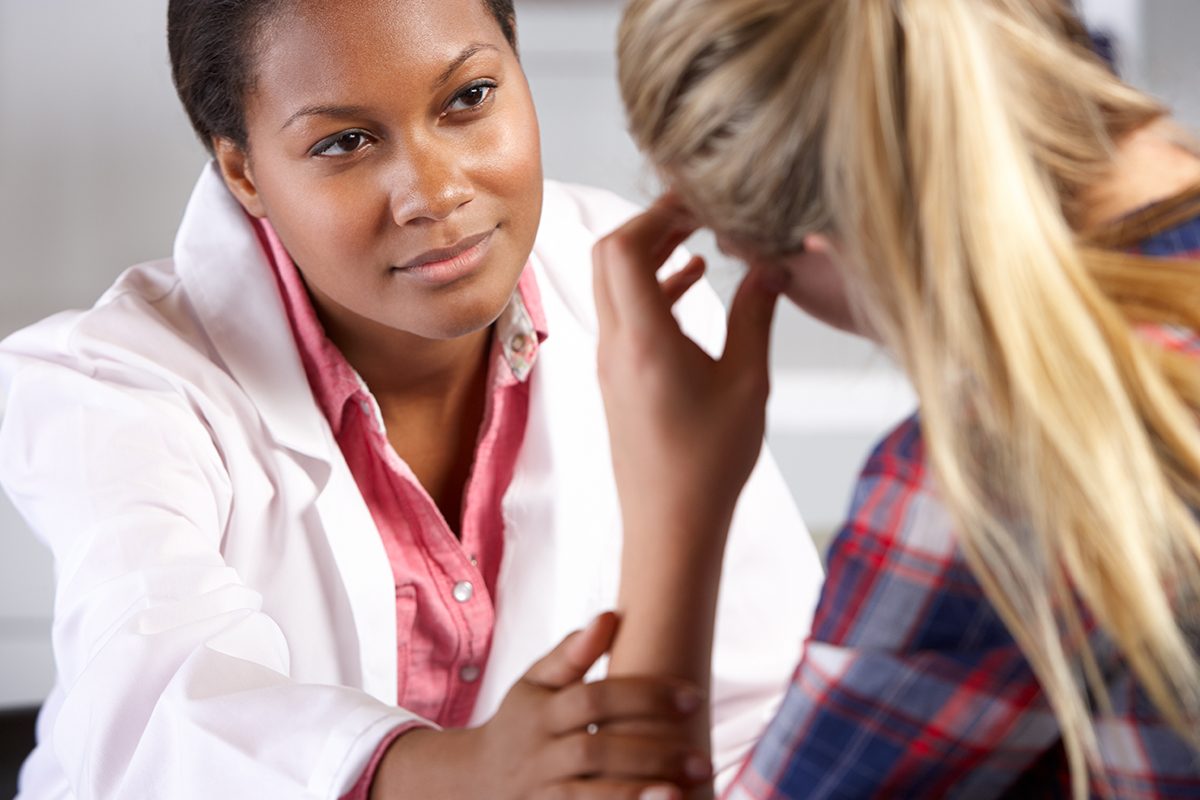 Teen girl meeting with a doctor.