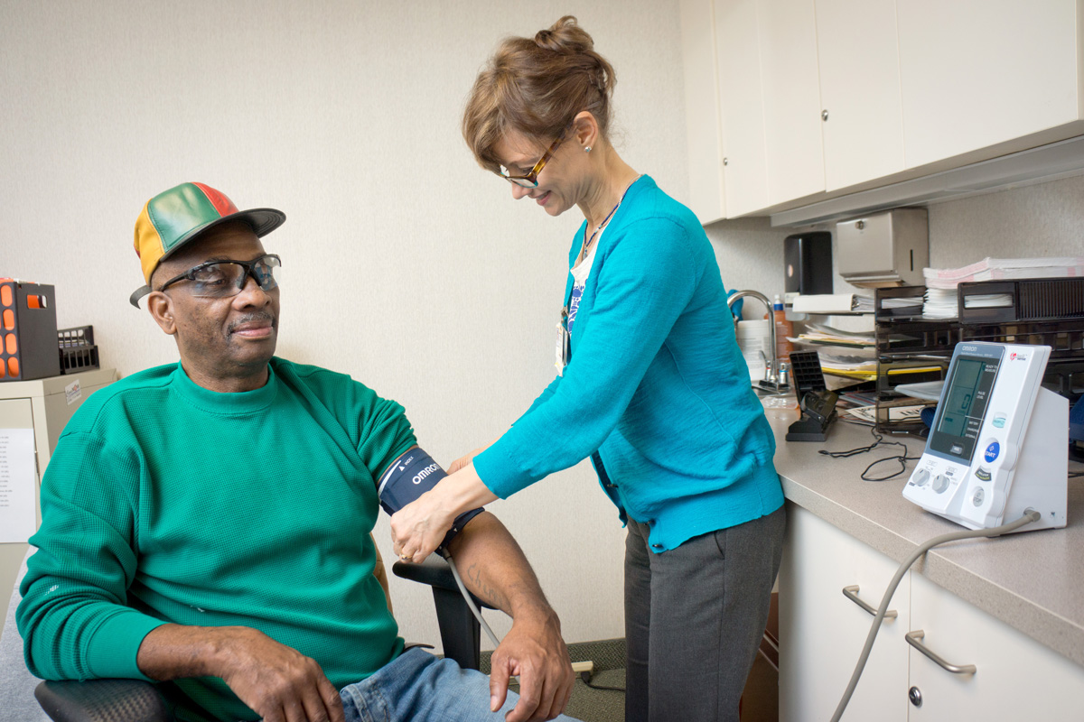 Man gets blood pressure taken by nurse.