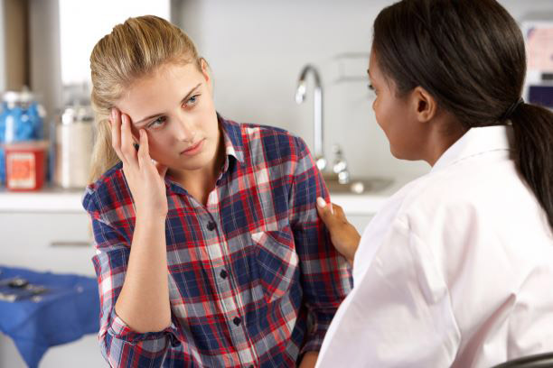 Image of a woman talking with doctor.