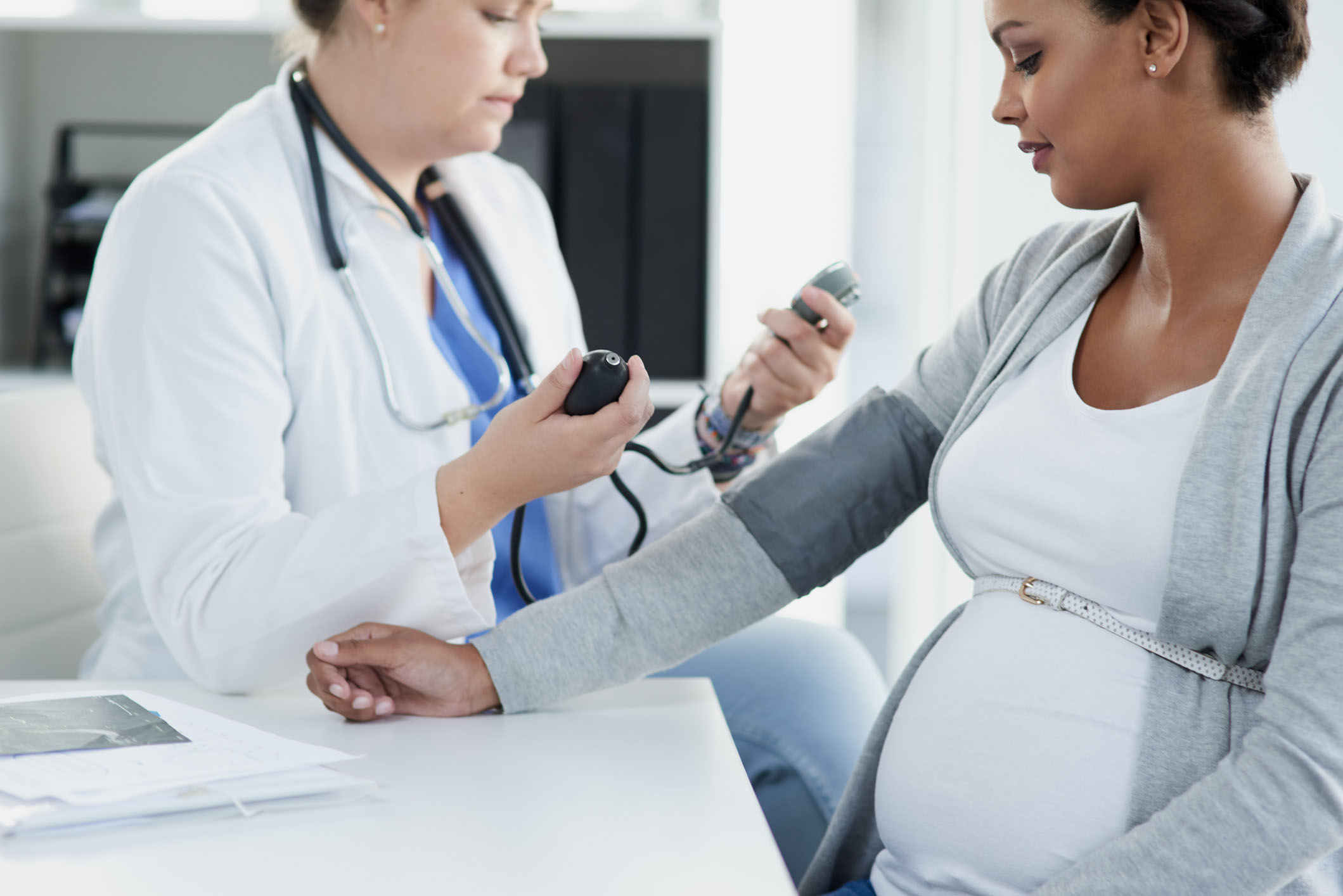 Pregnant woman getting blood pressure checked.
