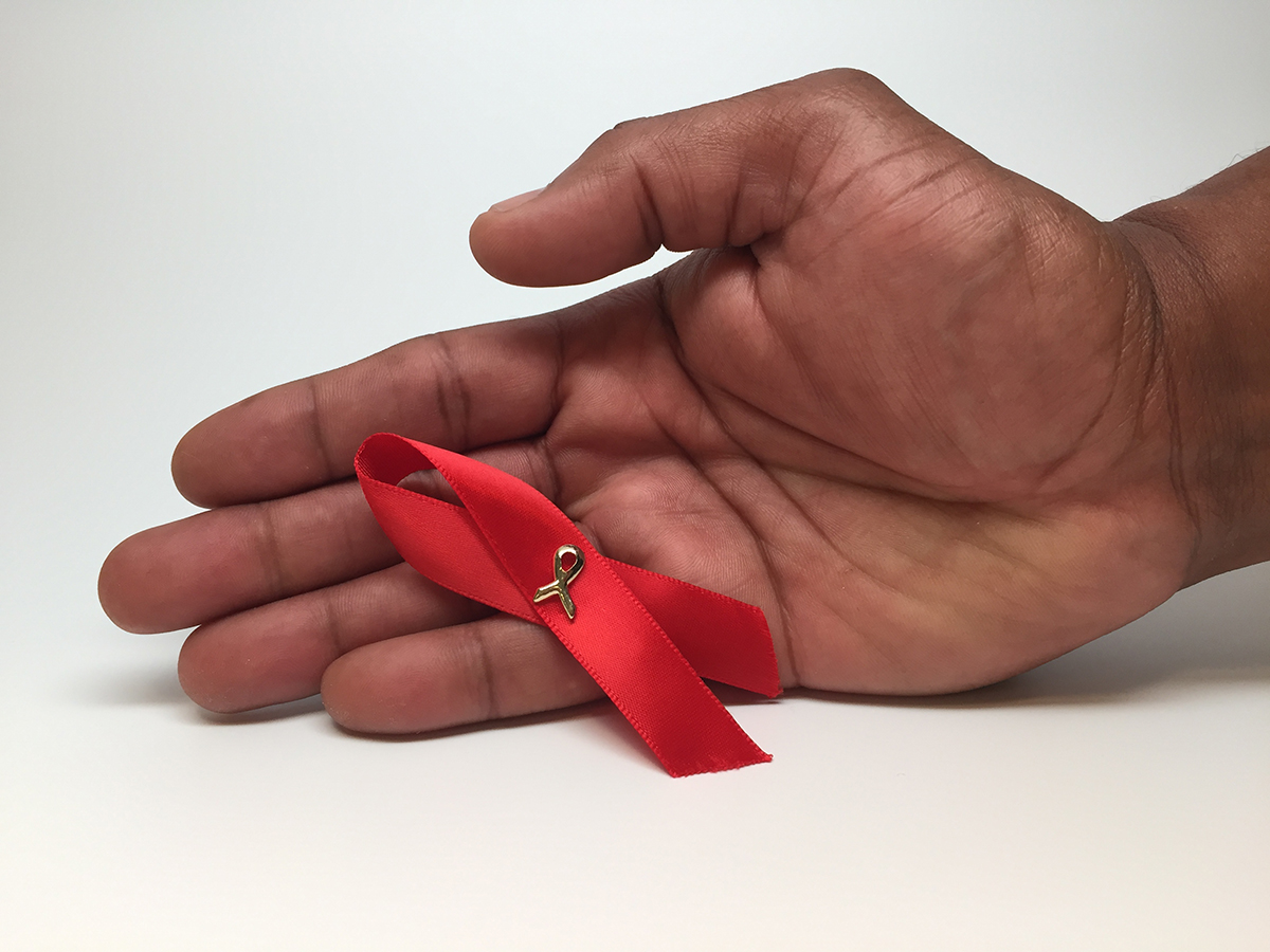 Image if a hand holding a ribbon
