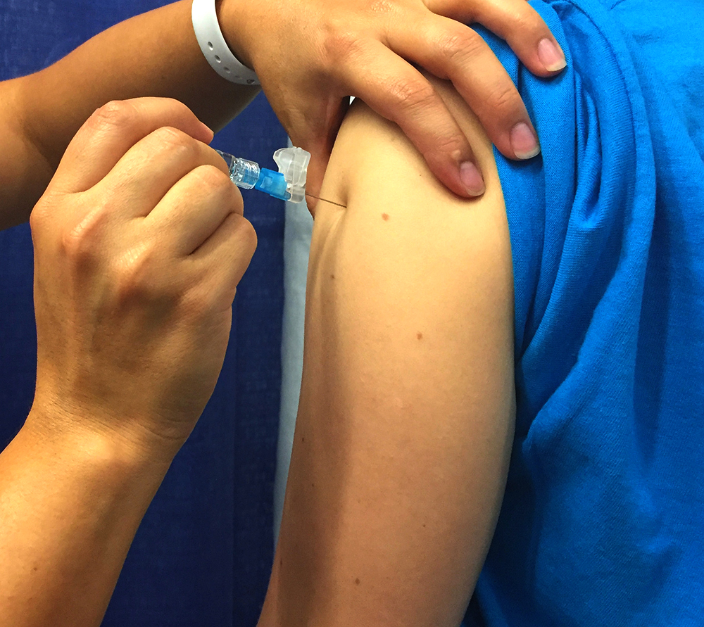A person receives the seasonal influenza vaccine (flu shot)
