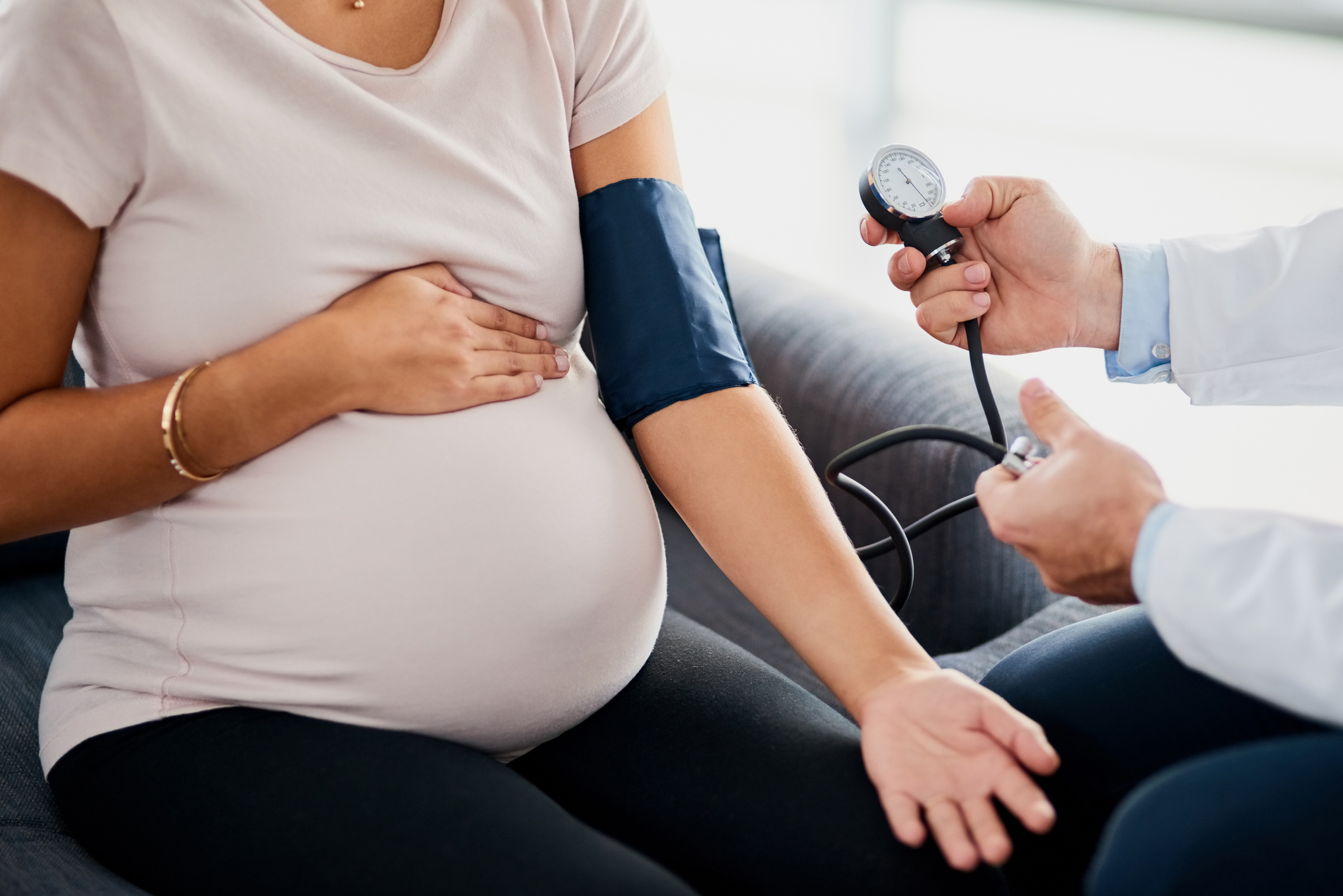 Image of a pregnant woman getting blood pressure taken.