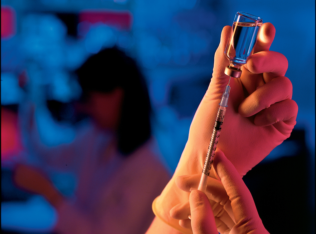 hands holding vaccine vial hands holding vaccine vial