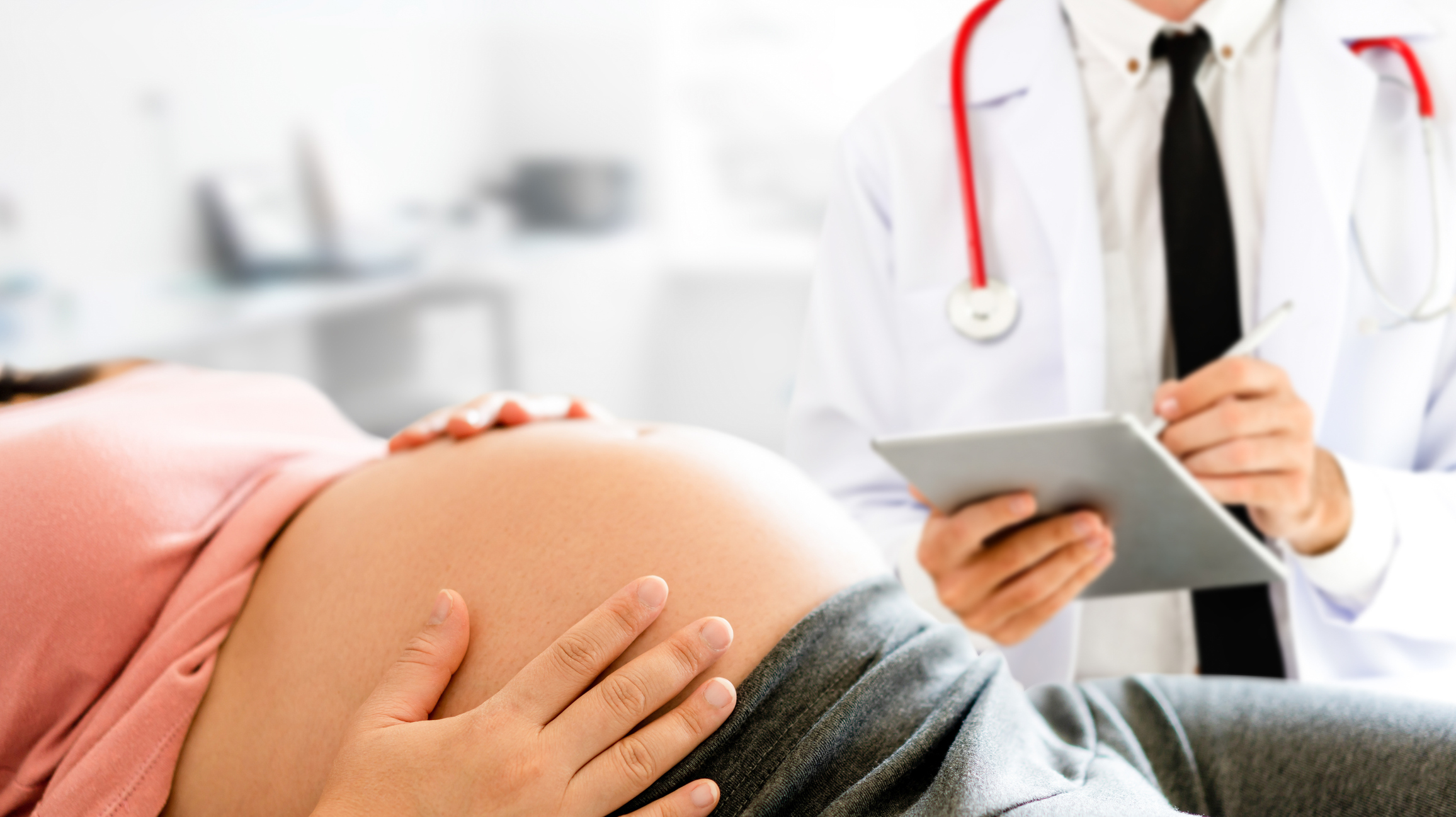 Pregnant Woman and Gynecologist Doctor at Hospital - stock photo