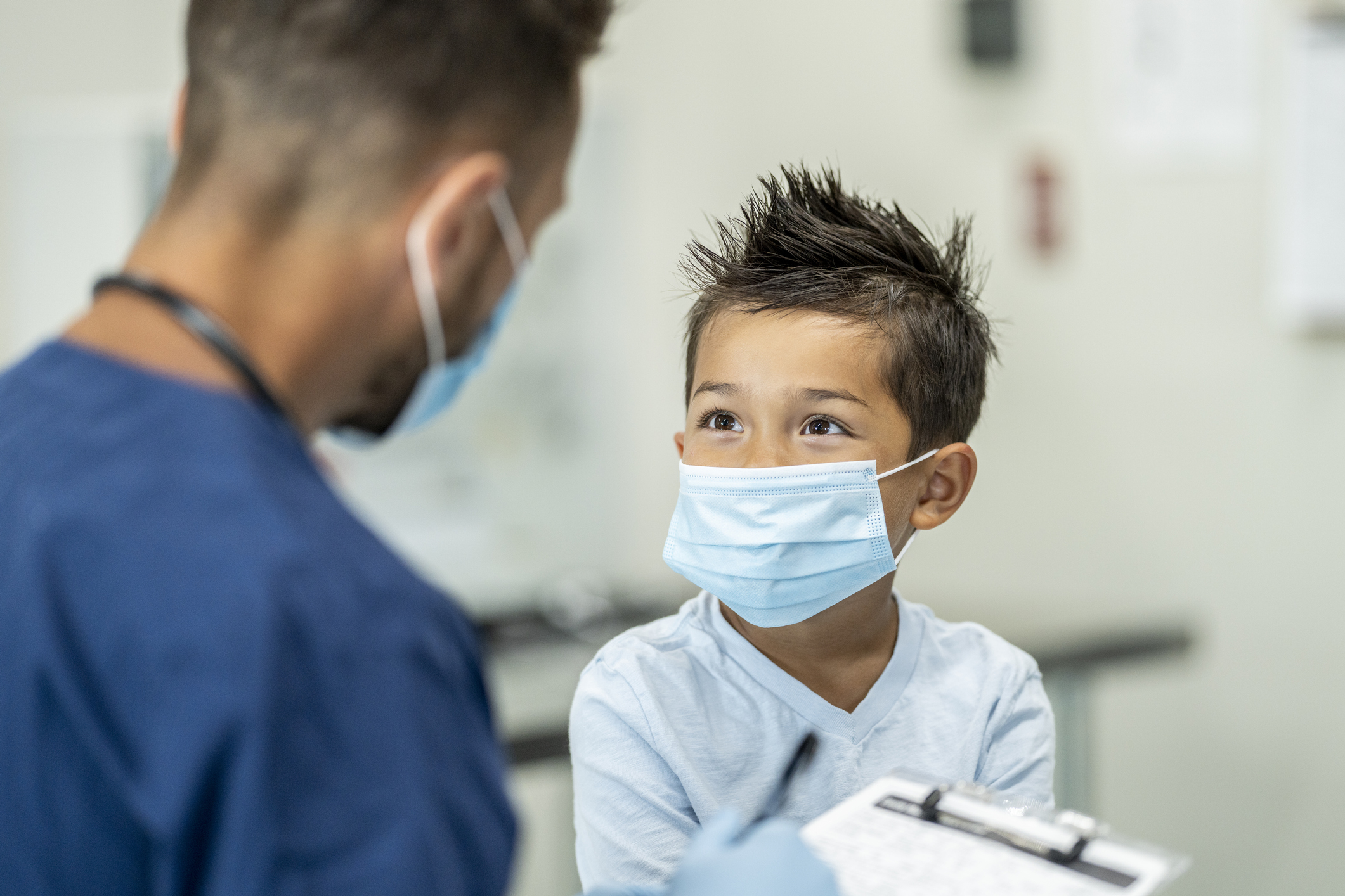 Young boy wearing a mask at a doctors appointment - stock photo