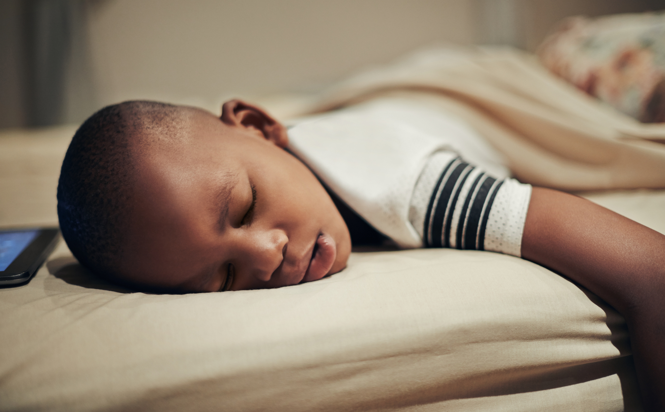 Shot of a young boy sleeping in bed