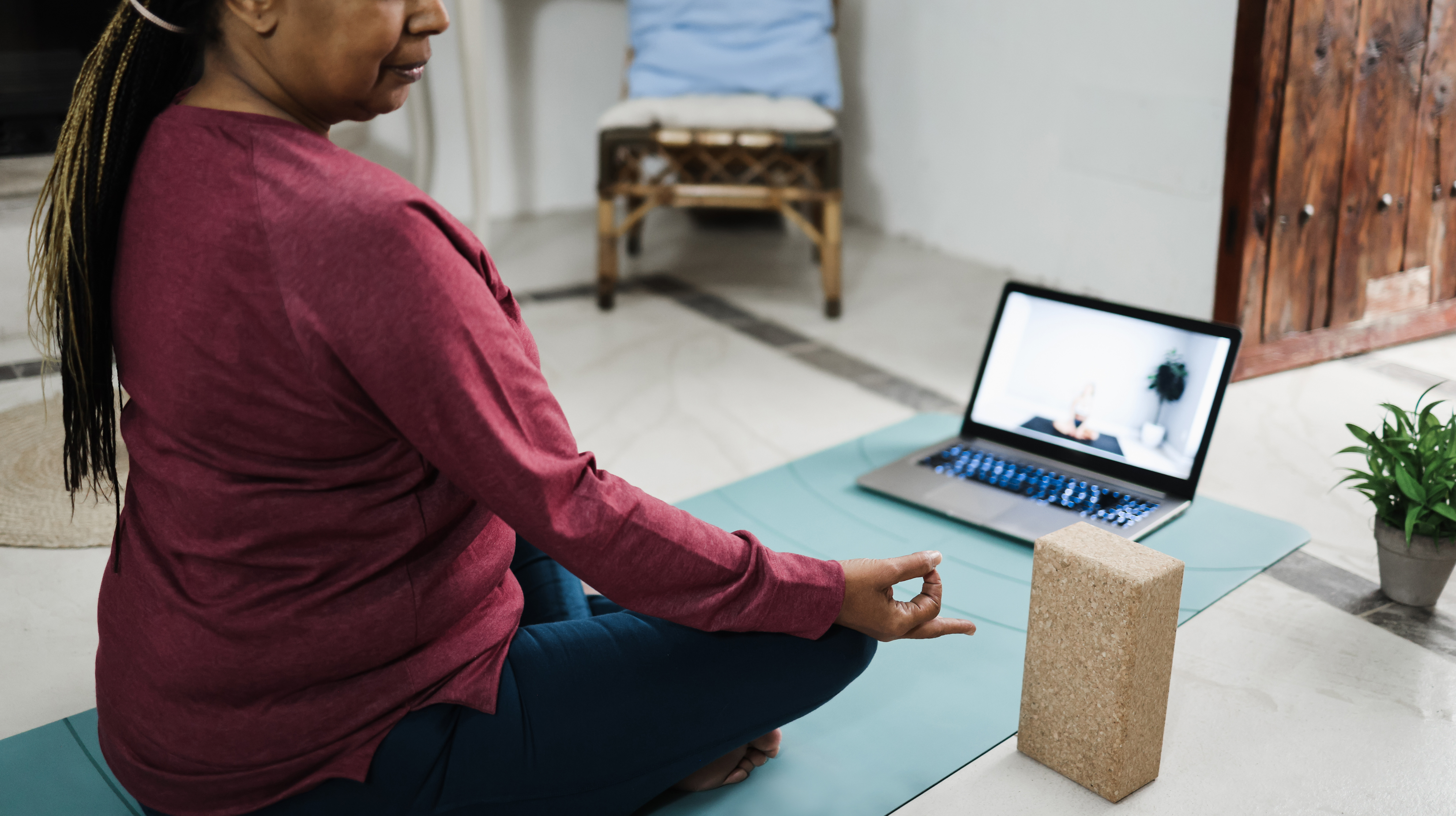 A woman doing yoga infront of TV
