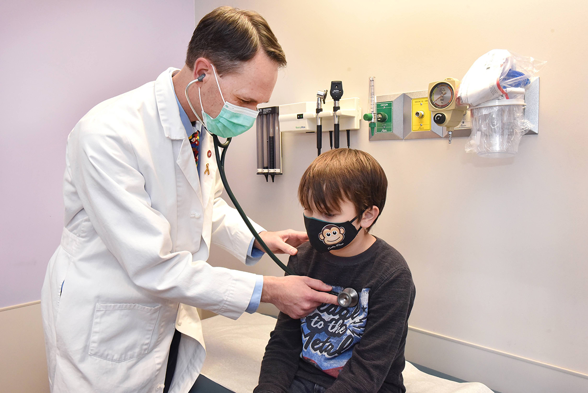 Image of a physician using a stethoscope to examine a child.