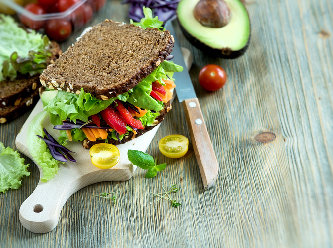 Vegan rye sandwich with fresh avocado, salad,veggies, healthy snack, vitamin and diet food copy space